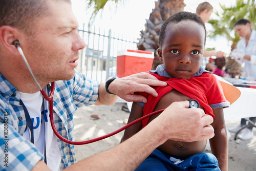 Bild auf Leinwand Volunteer, doctor and kid with help, community service and support with stethoscope