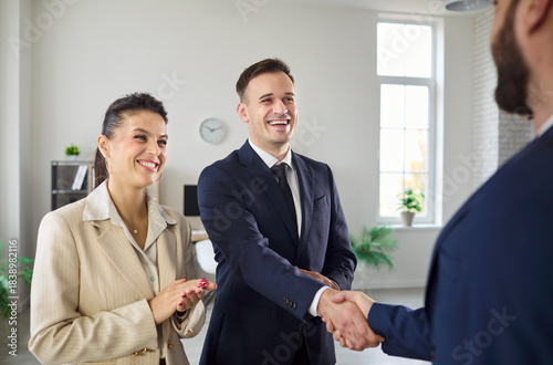 Business handshake shows teamwork during office meeting. Executives celebrate agreement and partnership, marking a deal, success, and cooperation. Concept shows partnership and trust.