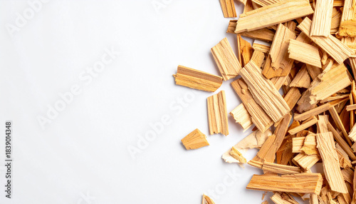 Scattered wood chips on white background. Crisp detail, natural tones, simple and clean presentation