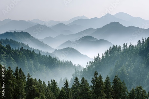 Clean, layered mountain ridges fading into soft, ethereal morning mist/fog, with green pine forests in the foreground, serene, volumetric light, cinematic, wide-angle,