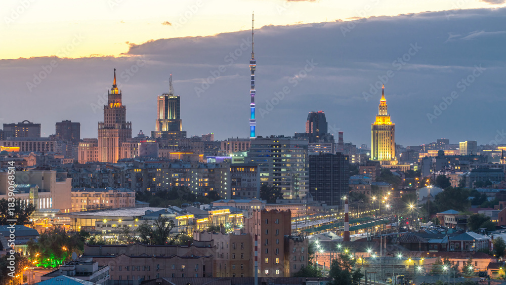 Fototapeta premium Ostankino tv tower and stalin skyscrapers near railway station day to night timelapse. Moscow, Russia