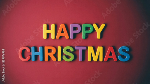 Happy Christmas Greeting with Colorful Plastic Letters on Red Festive Background
