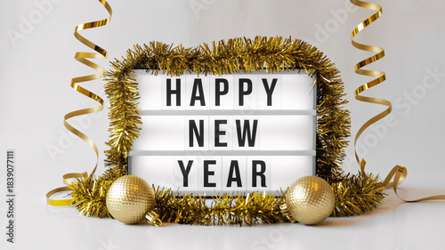 Happy New Year Celebration Lightbox with Gold Tinsel, Ornaments, and Ribbons on White Background