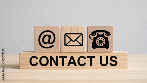 Contact Us Concept – Wooden Blocks with Email, Mail, and Phone Icons on Blue Gradient Background