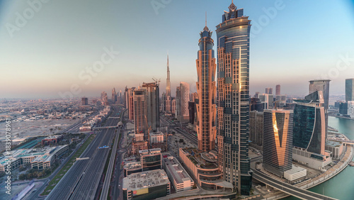 Sunset skyline with modern skyscrapers and traffic on sheikh zayed road timelapse in Dubai, UAE.