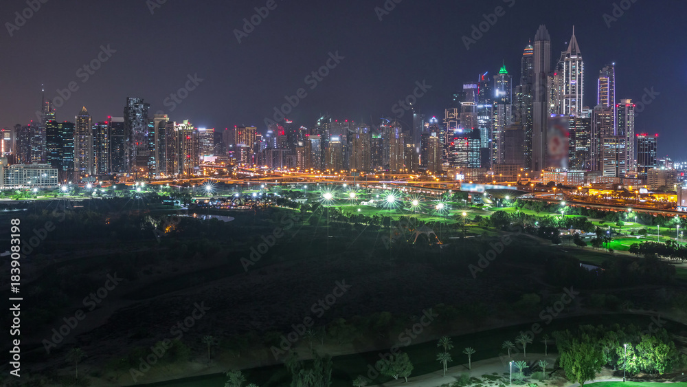 Fototapeta premium Dubai Marina skyscrapers and golf course day to night timelapse, Dubai, United Arab Emirates