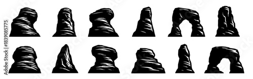 Silhouettes of tall rock formations with sharp carved surfaces. Each pillar shows distinct erosion patterns and rugged edges