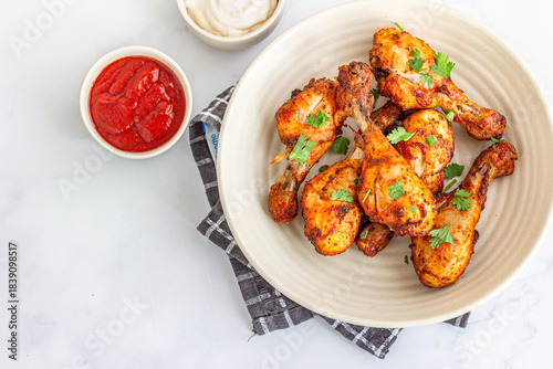 Healthy Oven-Baked Chicken Drumsticks Top Down Photo with Condiments