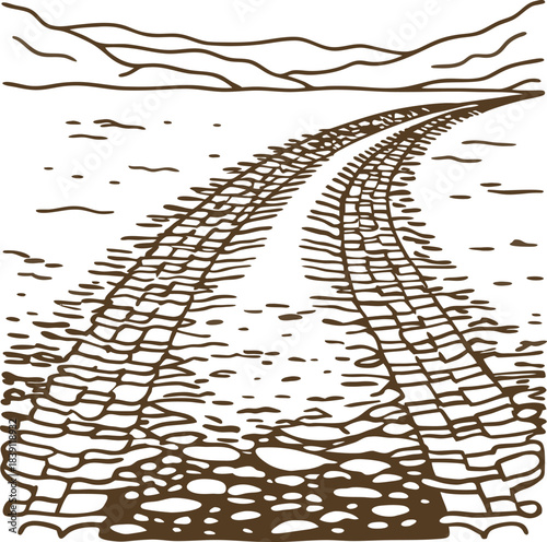 Curved tire tracks on rough gravel road leading toward distant mountains and cloudy horizon