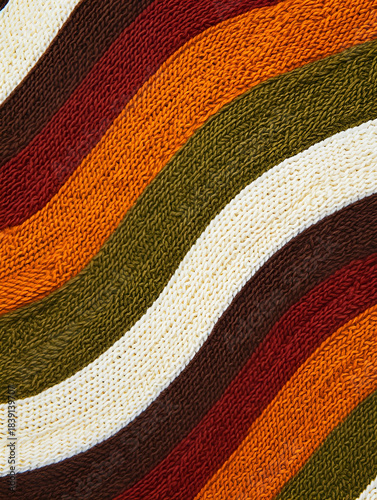Close up of curved knitted texture background with autumn colors stripes