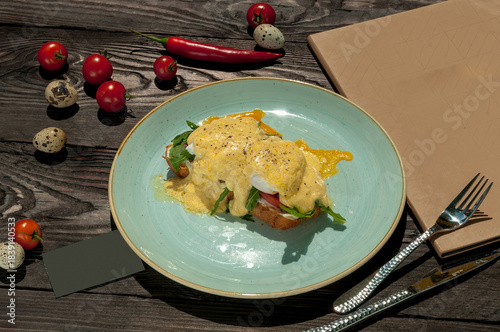 Bruschetta with arugula, salmon, poached egg and cheese on a plate on the table