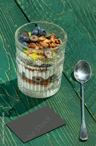 teramis in a glass decorated with blueberries and granola