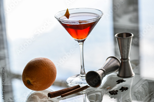 alcoholic cocktail sour in a martini glass on a glass table with barware