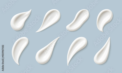 Cosmetic smears of creamy texture isolated on blue background. Set of cosmetic cream swatches. Cosmetic skin care product. Vector realistic illustration