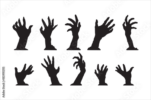 Creepy undead zombie hands silhouettes rising from ground for horror
