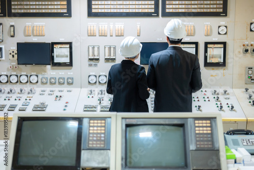 Obraz na plátně Inside the advanced power plant, a team of male and female engineers coordinates energy control operations, upgrading industrial systems with modern engineering tools to produce energy for export
