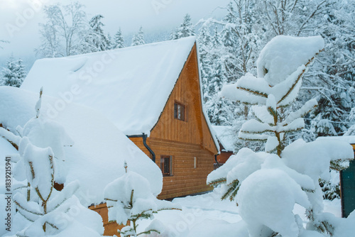 Tableau sur toile Cozy Snowy Winter Village with Traditional Houses and Peaceful Rural Landscape