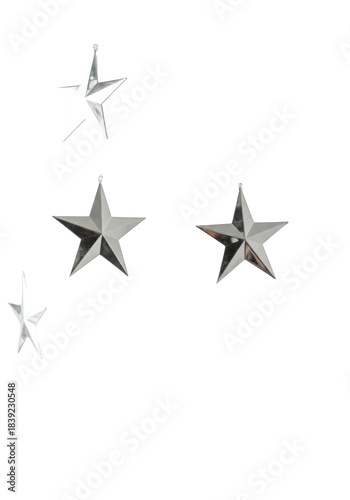 Suspended cascading garland of polished metallic silver stars and intricately detailed white snowflakes against a brilliant high-key studio background, concept of sophisticated commercial holiday