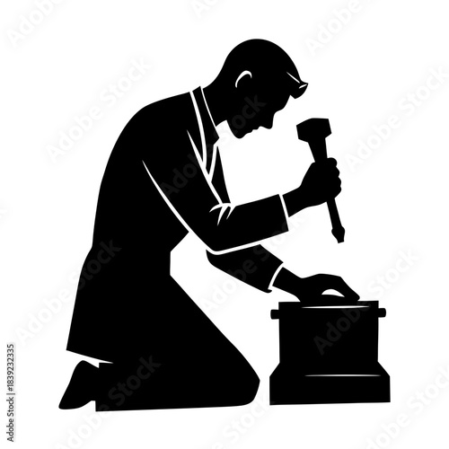 Worker kneels and uses hammer on box in an indoor space during working hours