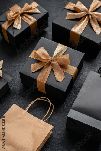 A monochrome Black Friday layout featuring black boxes with bows and matching bags against a fully black backdrop with open copy area