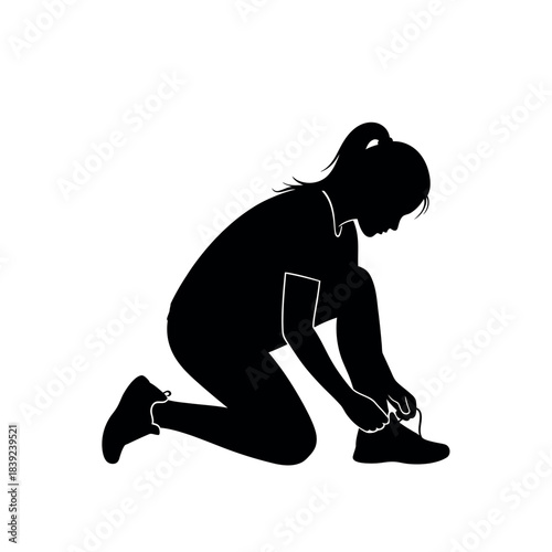 Silhouette of a woman tying her shoelaces preparing for exercise or a run.