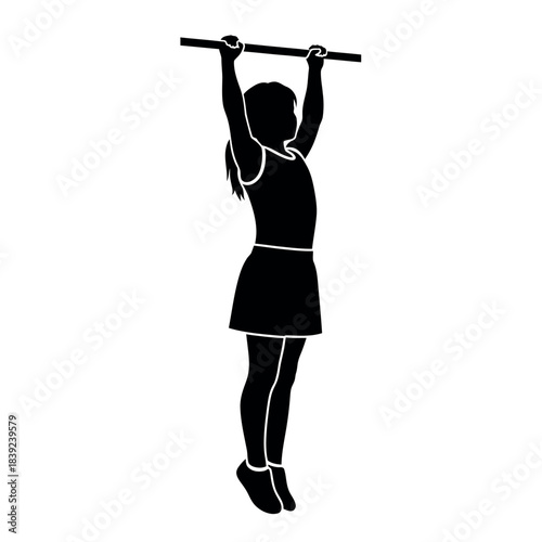 Silhouette of a young girl hanging from a horizontal bar.