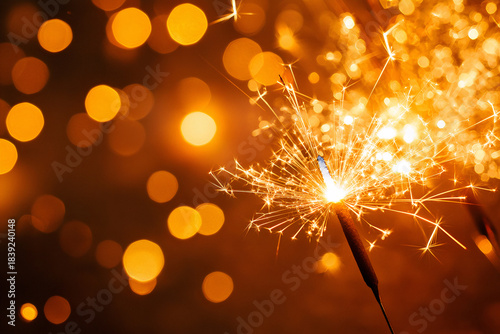 Sparkler on a golden background - Christmas Celebration