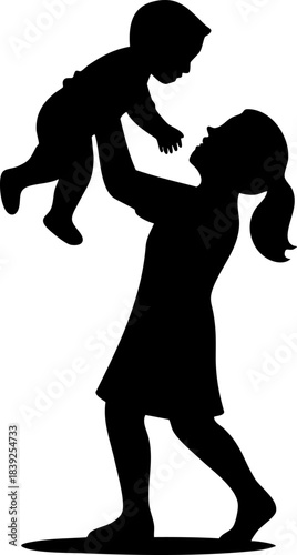 Silhouette of woman lifting baby joyfully in loving playful moment