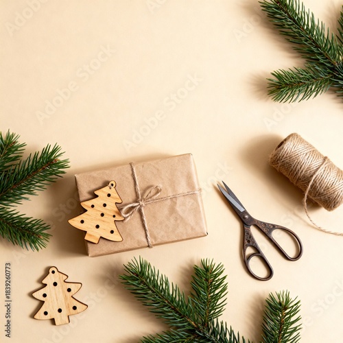 Eco-friendly New Year gift wrapping with kraft paper, jute twine and wooden Christmas tree ornament on beige background, flat lay, copy space