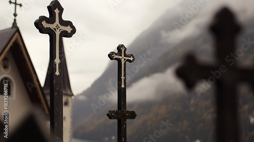 Crosses stand in silent testament against a backdrop of misty mountains, evoking serenity and reflection. A symbol of faith, hope, and remembrance in a tranquil setting.