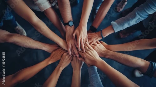 Many hands joined together in a circle