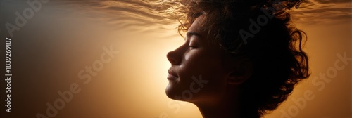 Wallpaper Mural Serene profile of young caucasian female underwater in warm light Torontodigital.ca