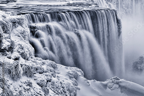 niagara falls from prospect point with diminished frozen flow during an extreme cold period and polar vortex from niagara falls state park