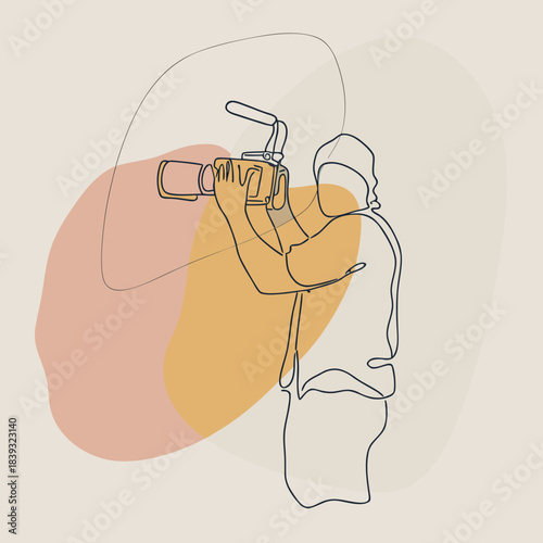 Male videographer filming with camera in abstract design