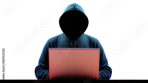 Hooded figure sitting at desk with laptop, mysterious faceless person in dark hoodie using computer, cyber security threat, hacker concept, digital crime, anonymity, technology background