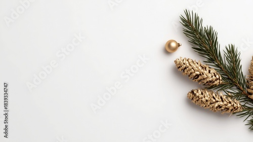 Christmas decor featuring golden glitter pinecones, green pine branch, and gold ornament placed on plain white background. Festive holiday decoration, elegant seasonal design ideal for wallpaper