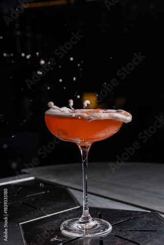 A delicious alcoholic cocktail at the bar. The bartender prepares cocktails
