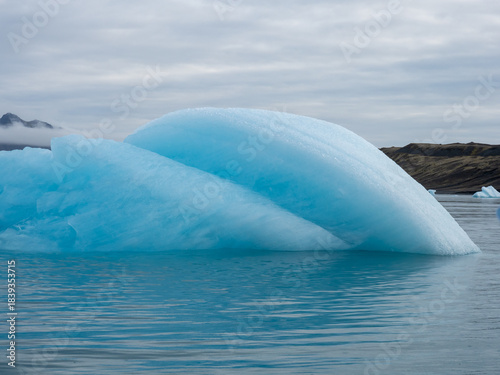 Beautiful round blue iceberg floating in Iceland's Jokulsarlon Glacier Lagoon