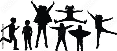 Silhouettes of joyful children jumping and playing with arms raised in the air