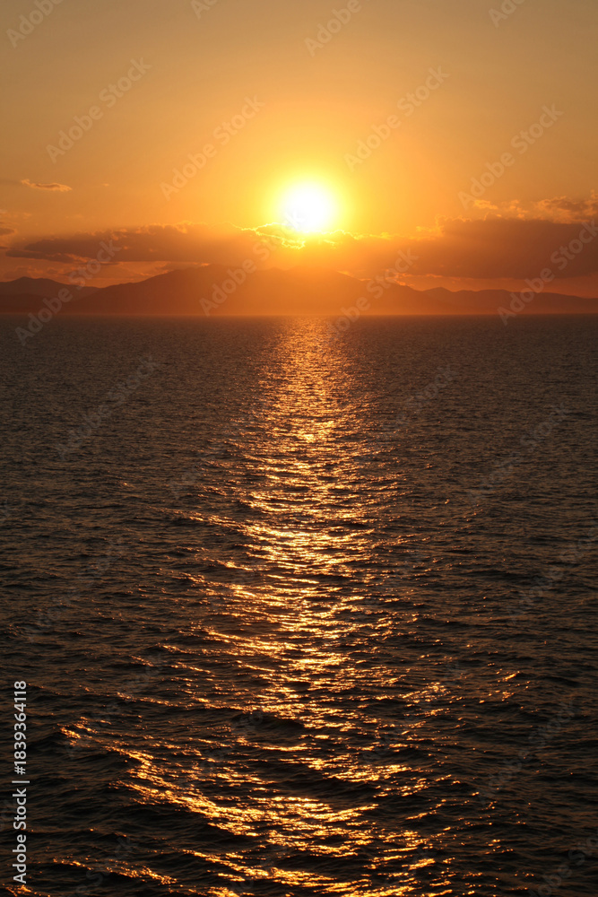 Fototapeta premium Beautiful orange Mediteranean sunset off the coast of Spain.
