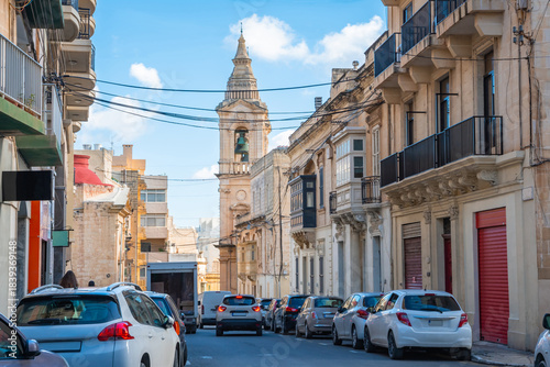 Cozy street and traditional colorful wooden balconies in Sliema, Malta