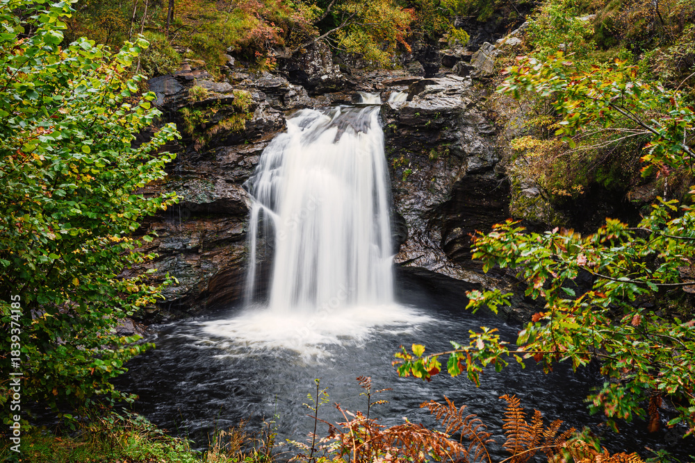 Obraz premium Falls of Falloch in early autumn, situated in the north of Loch Lomond and The Trossachs National Park, Falls of Falloch is a beautiful waterfall just 3 miles from the village of Crianlarich