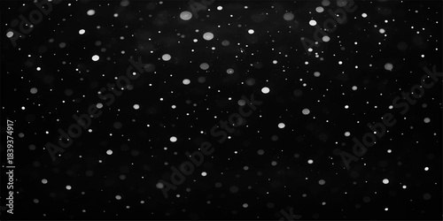 Dark winter night sky with falling snowflakes and distant starry light