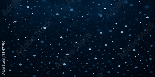 Blue winter night sky with snowflakes falling and a galaxy of starry light