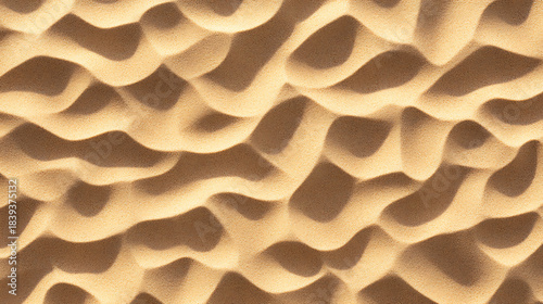 Warm sand dune texture background with flowing abstract ripples and soft shadow pattern evoking calm desert mood