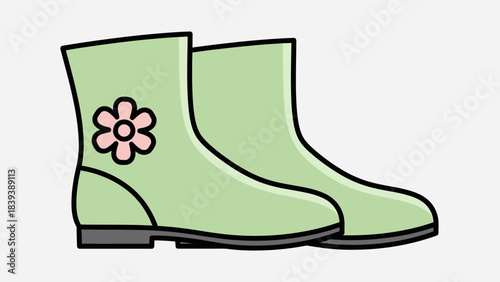 A pair of light green rain boots with a pink flower design on the side of one boot.
