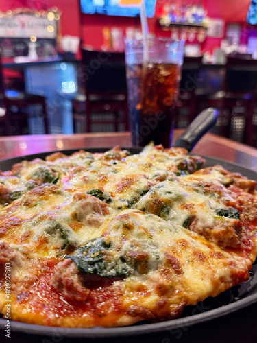 Enjoying Pizza and Soda at a Pub With Friends During a Casual Evening Out