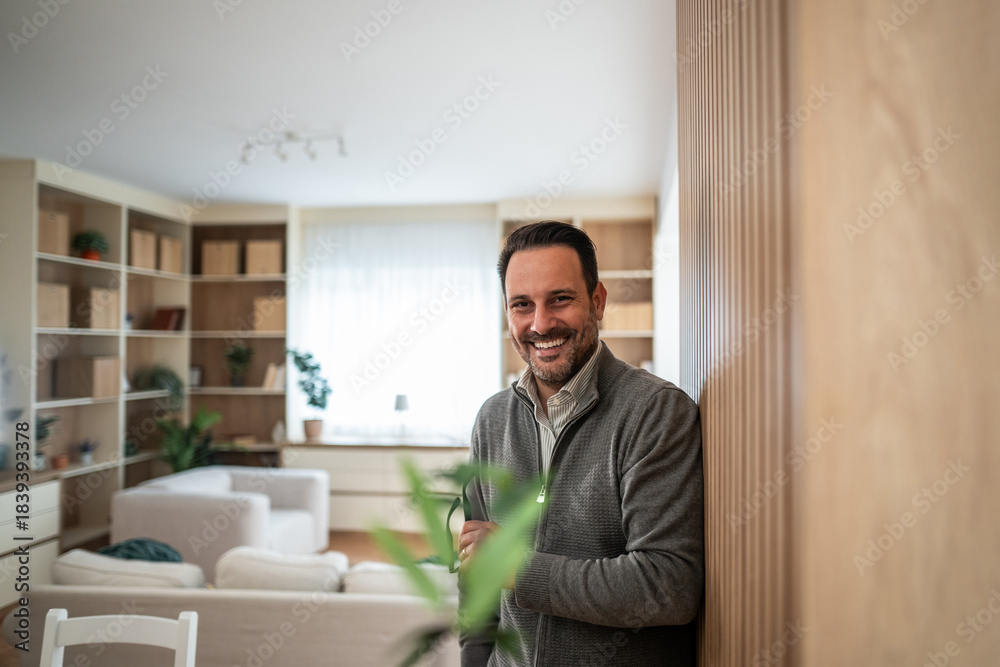 Fototapeta premium Man smiling portrait in modern living room at home