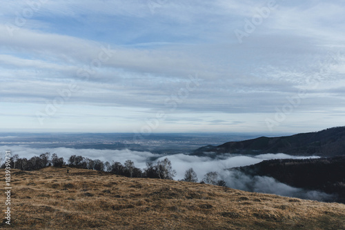 low clouds over the mountains in cold winter with hills