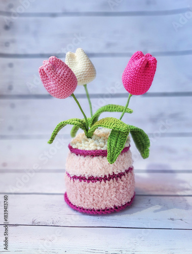 A crochet basket made from colorful jute with flowers